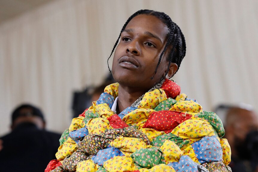 ASAP Rocky wearing a quilted, puffy, multicoloured coat from pattered fabric