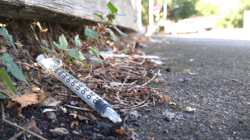 A used needle in a Richmond gutter