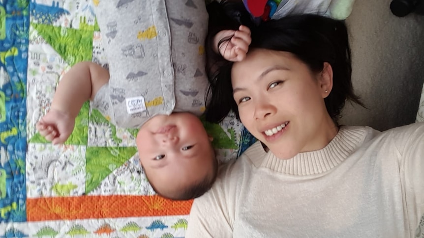 Skye and her son Benny laying on a mat for a story about dealing with baby blues and sharing the parenting load.