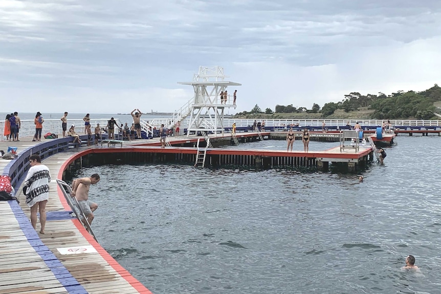 People swim at Geelong's Eastern Beach on a hot day.