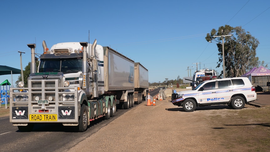 A truck drives past a border checkpoint in the outback.