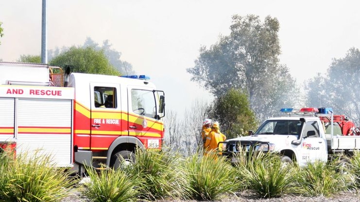 Fire crews surrounded by smoke on the border of the Noosa National Park