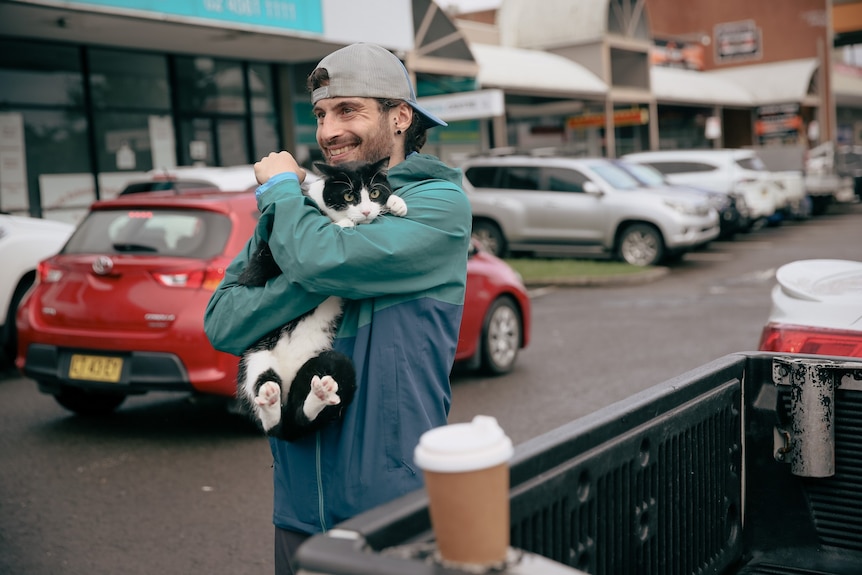 A man holding his cat