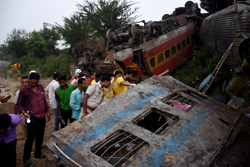 Rescue workers search for survivors after two passenger trains collided in India.