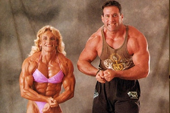 Bev and Steve do a muscle pose