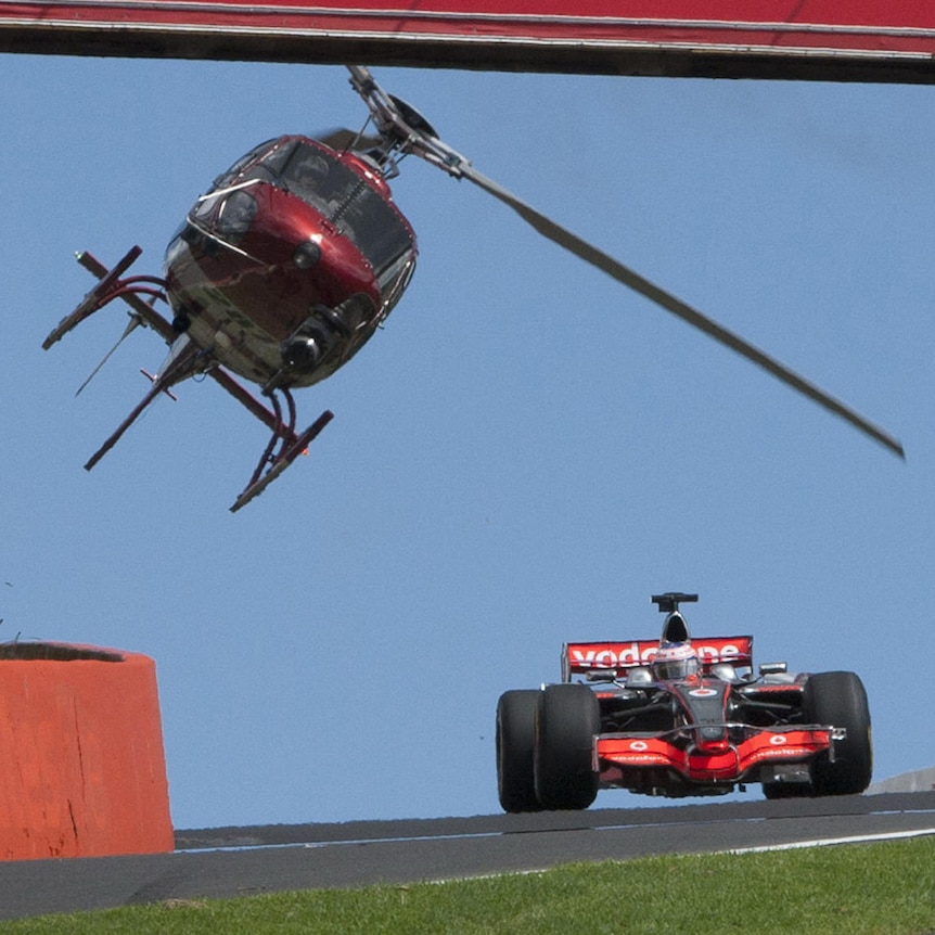 A helicopter films Jenson Button's record lap around the Mount Panorama circuit.