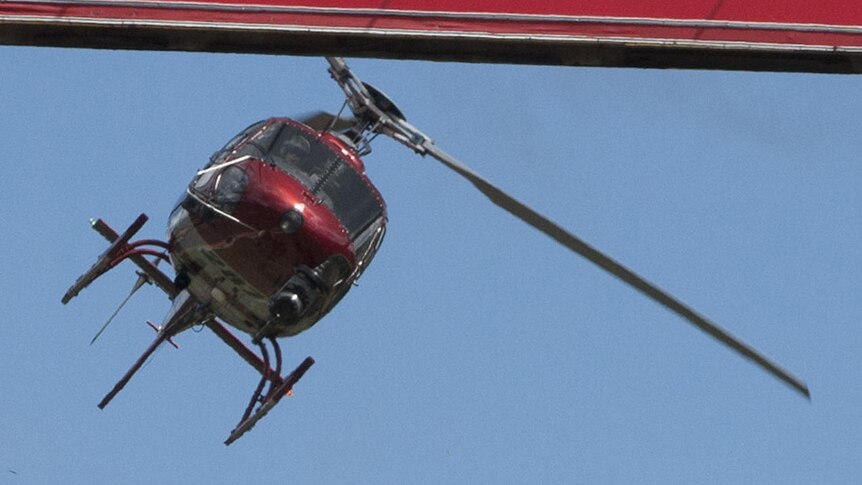 A helicopter films Jenson Button's record lap around the Mount Panorama circuit.