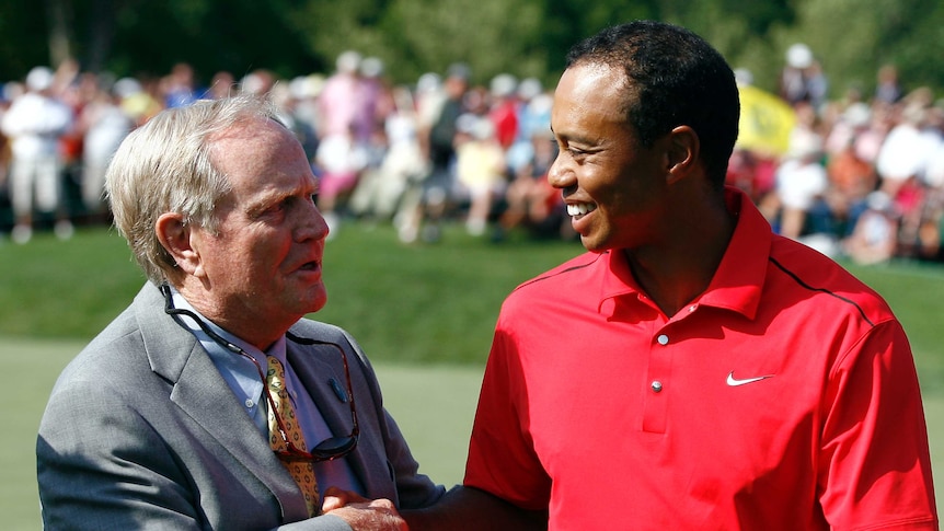 Tiger Woods is congratulated by Jack Nicklaus.