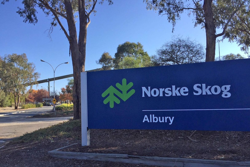 A blue sign displays the words 'Norske Skog Albury' next to a road.