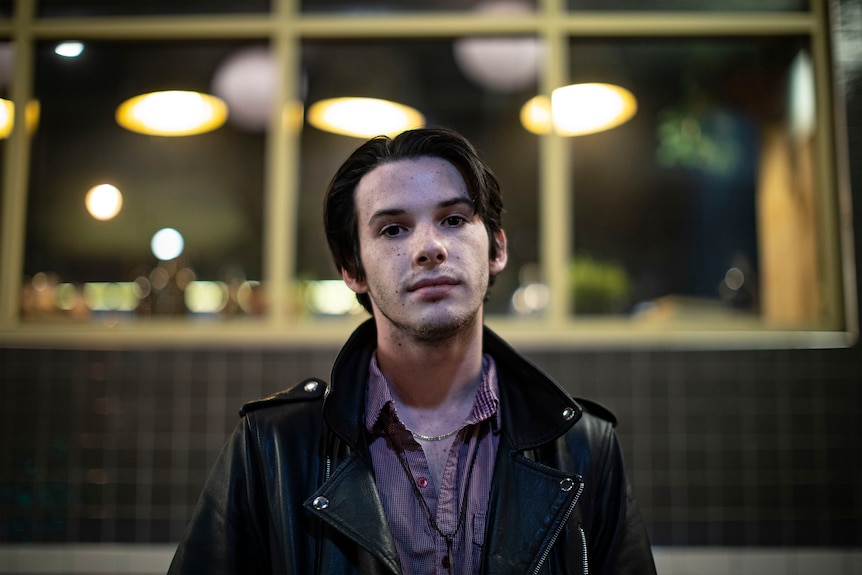 Kieran Straub Duddy wears a leather jacket inside a pub.