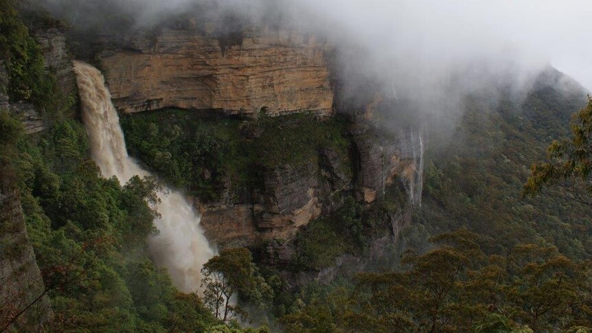 A waterfall flows heavily in the Blue Mountains
