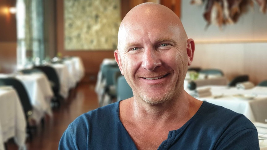 Matt Moran sits in a restaurant