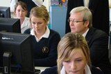 Rudd sits with high school students at computers