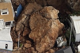 A landslip crushes buildings in Sumner, Christchurch