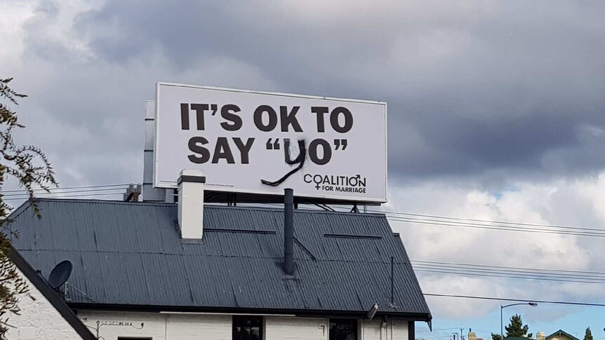 A billboard vandalised so it says it's OK to say "yo"