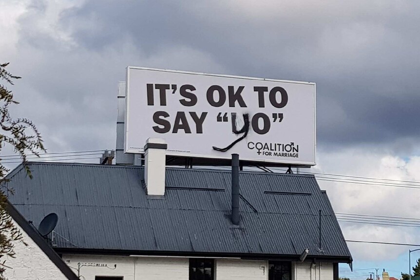 A billboard vandalised so it says it's OK to say "yo"