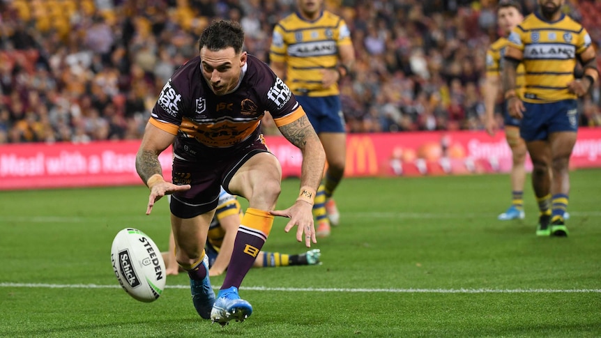 Darius Boyd watches a ball bouncing in front of him as he prepares to fall on it