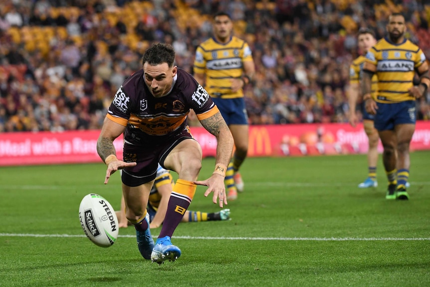 Darius Boyd watches a ball bouncing in front of him as he prepares to fall on it