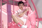 Zhang Yangzi posing in pink on a toy horse