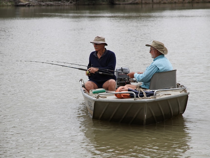 Two men fish from their tinny on the River Murray