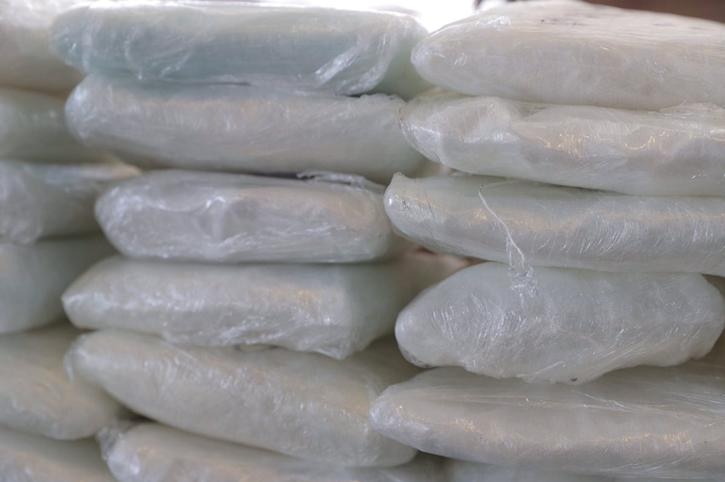 Up to 19 packets of white powder fentanyl seen wrapped in gladwrap on top of each other.