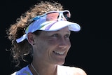 A female Australian tennis player claps her hands at the Australian Open.