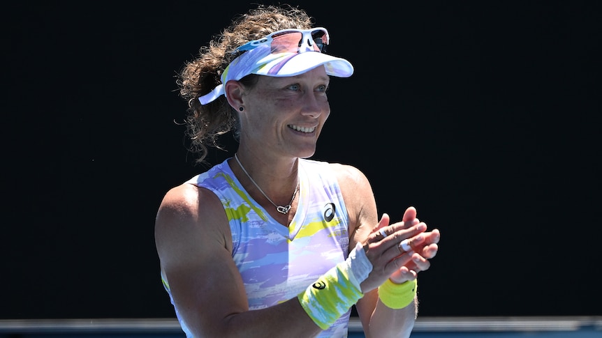 A female Australian tennis player claps her hands at the Australian Open.