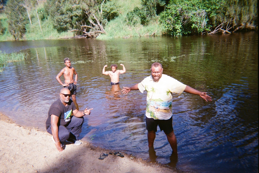 Four men in a creek