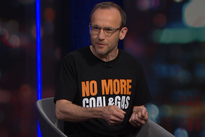 Adam Bandt wears a t-shirt with an anti-coal message on it.
