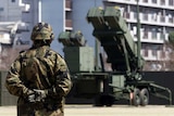 A soldier stands guard near Patriot Advanced Capability-3 (PAC-3) missile units