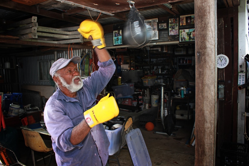 man punching bag in his shed
