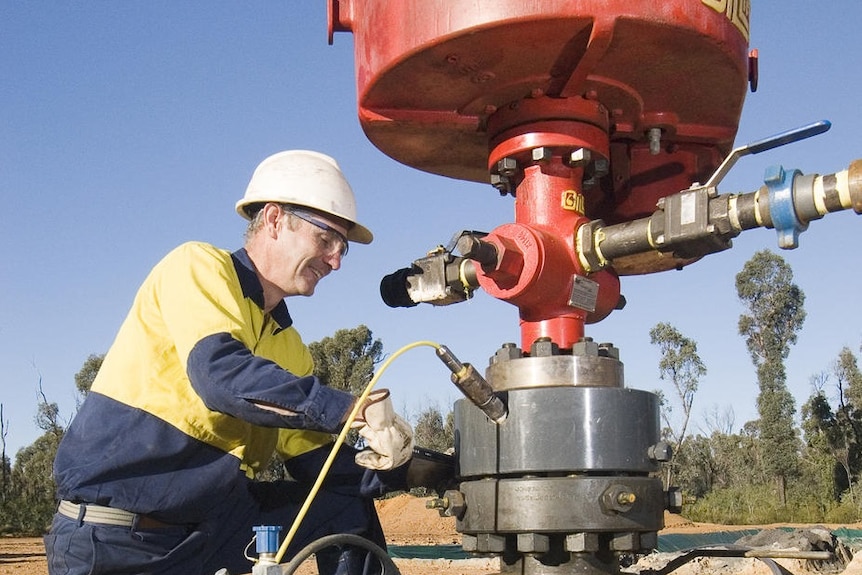 A miner works on a coal seam gas bore hole near Narrabri.