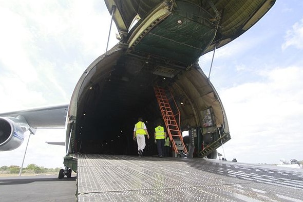 The nose of a Russian Antonov AN-124 is lifted and a ramp lowered to load military cargo