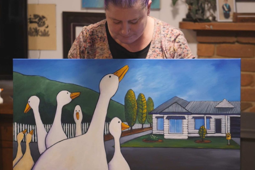 An artist and her paintings of geese