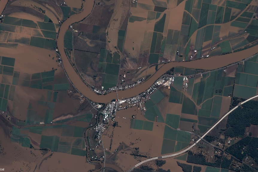 Aerial picture of flooded town on a river.
