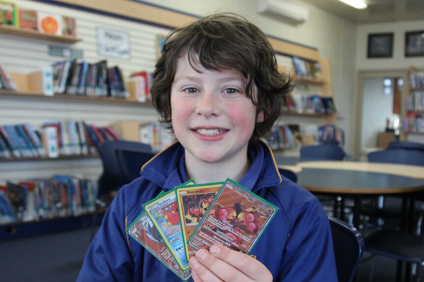 Daniel Mooney holds up some of his cards
