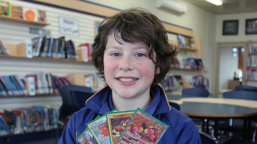 Daniel Mooney holds up some of his cards