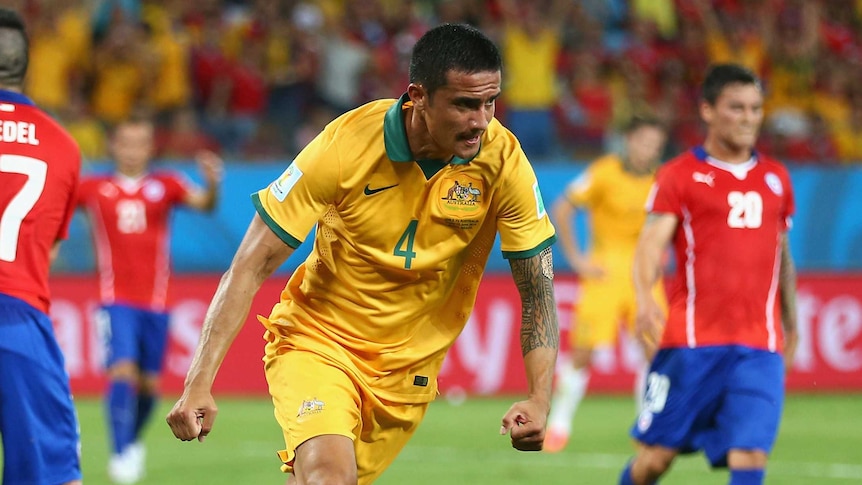 Tim Cahill celebrates scoring for Australia against Chile at the World Cup.