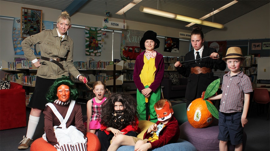 Children dressed as Roald Dahl characters sit in the library.