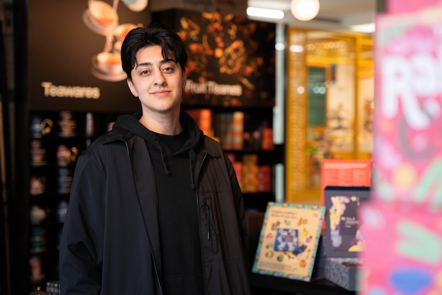 A man standing in a tea shop.