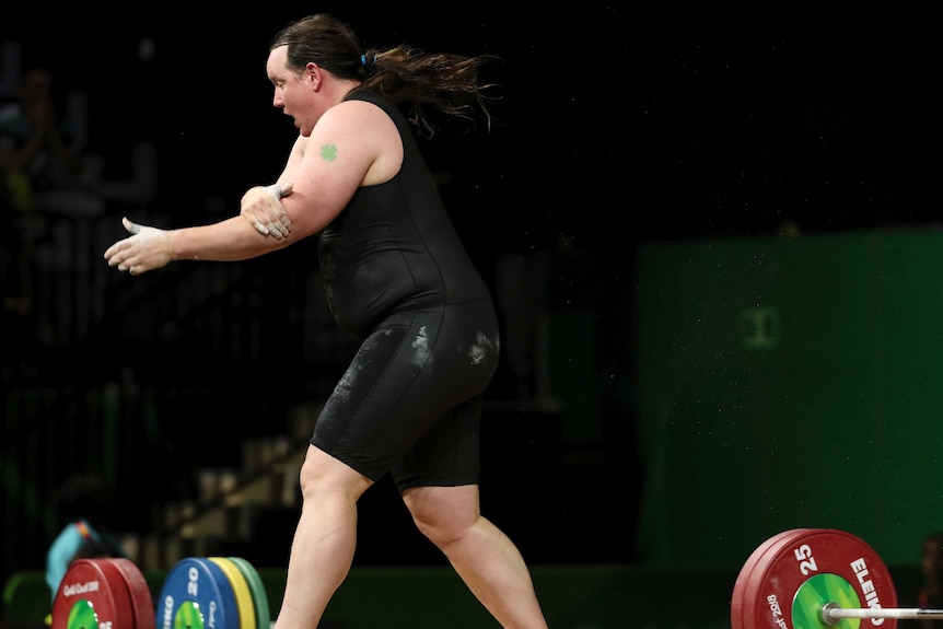 New Zealand's Laurel Hubbard clutches her arm.