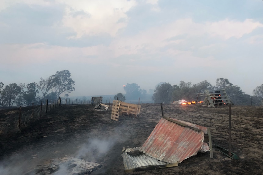 a burnt shed lying on the burnt ground