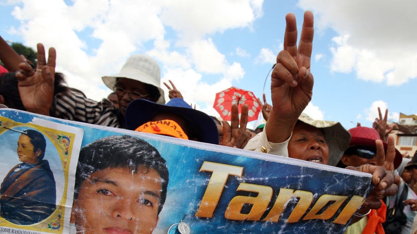 Members of Madagascar's opposition party (TGV) carry a poster of opposition leader Andry Rajoelina during a rally in Antananarivo on March 13, 2009 amidst the months-old political crisis.
