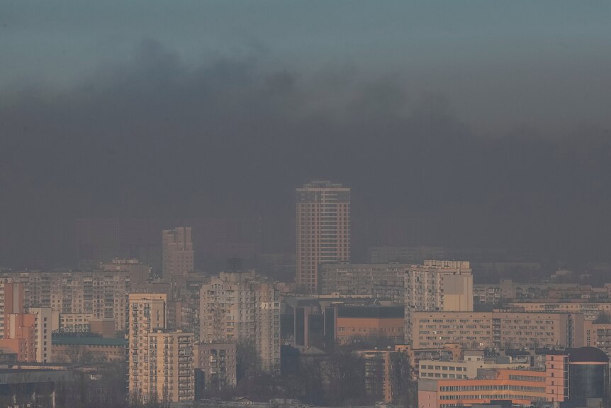 Residential buildings are seen through smoke from fires after shelling on the outskirts of the capital.