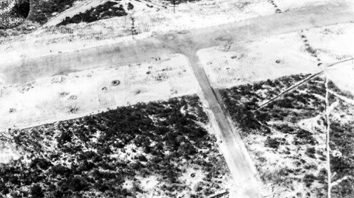 Small craters pock mark the surface of the horn island airstrip following a Japanese bombing raid during WWII.