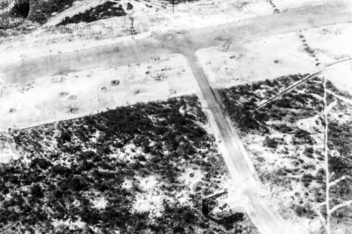 Small craters pock mark the surface of the horn island airstrip following a Japanese bombing raid during WWII.