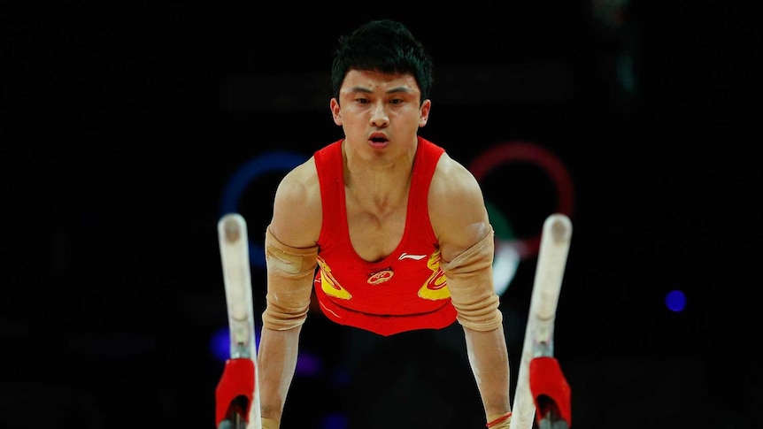 China's Feng Zhe competes in the men's gymnastics parallel bars