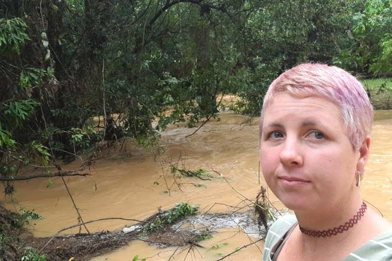 Summa Court takes a selfie in front of a swollen creek.
