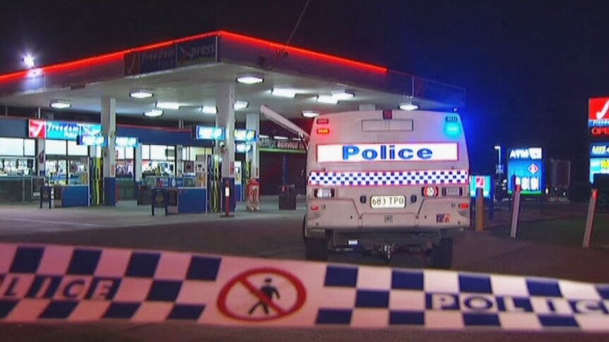 Police at a Caboolture service station where a man walked into with a stab wound to the abdomen