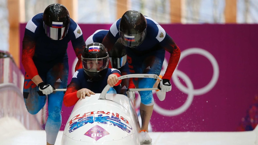 Russian crew start during a heat of the four-man bobsleigh event at the 2014 Sochi Olympics.